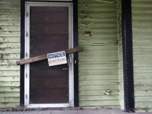 a boarded up door with an eviction notice
