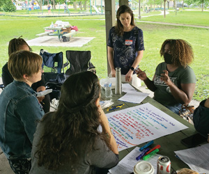 a group of people collaborating around posterboard